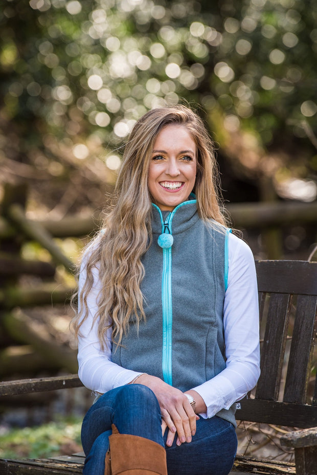 smiling model wearing ladies grey fleece gilet with sky blue trim