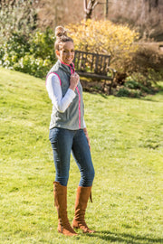 model in garden wearing ladies grey fleece gilet with bright pink trim