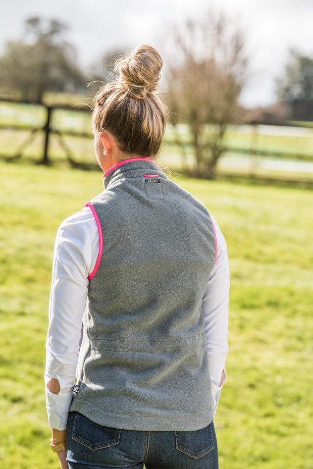 model back view of ladies grey fleece gilet with bright pink trim