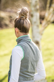 model in garden wearing ladies grey fleece gilet with mint green trim