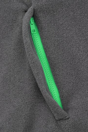 pocket detail of grey fleece quarter zip with bright green trim
