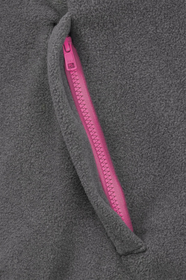 pocket detail of nattily dressed grey fleece quarter zip with bright pink trim