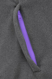 pocket detail of nattily dressed grey fleece quarter zip with purple trim