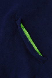 pocket detail of nattily dressed navy blue fleece quarter zip with lime green trim