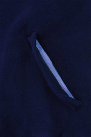 pocket detail close up of nattily dressed navy blue fleece quarter zip with purple trim